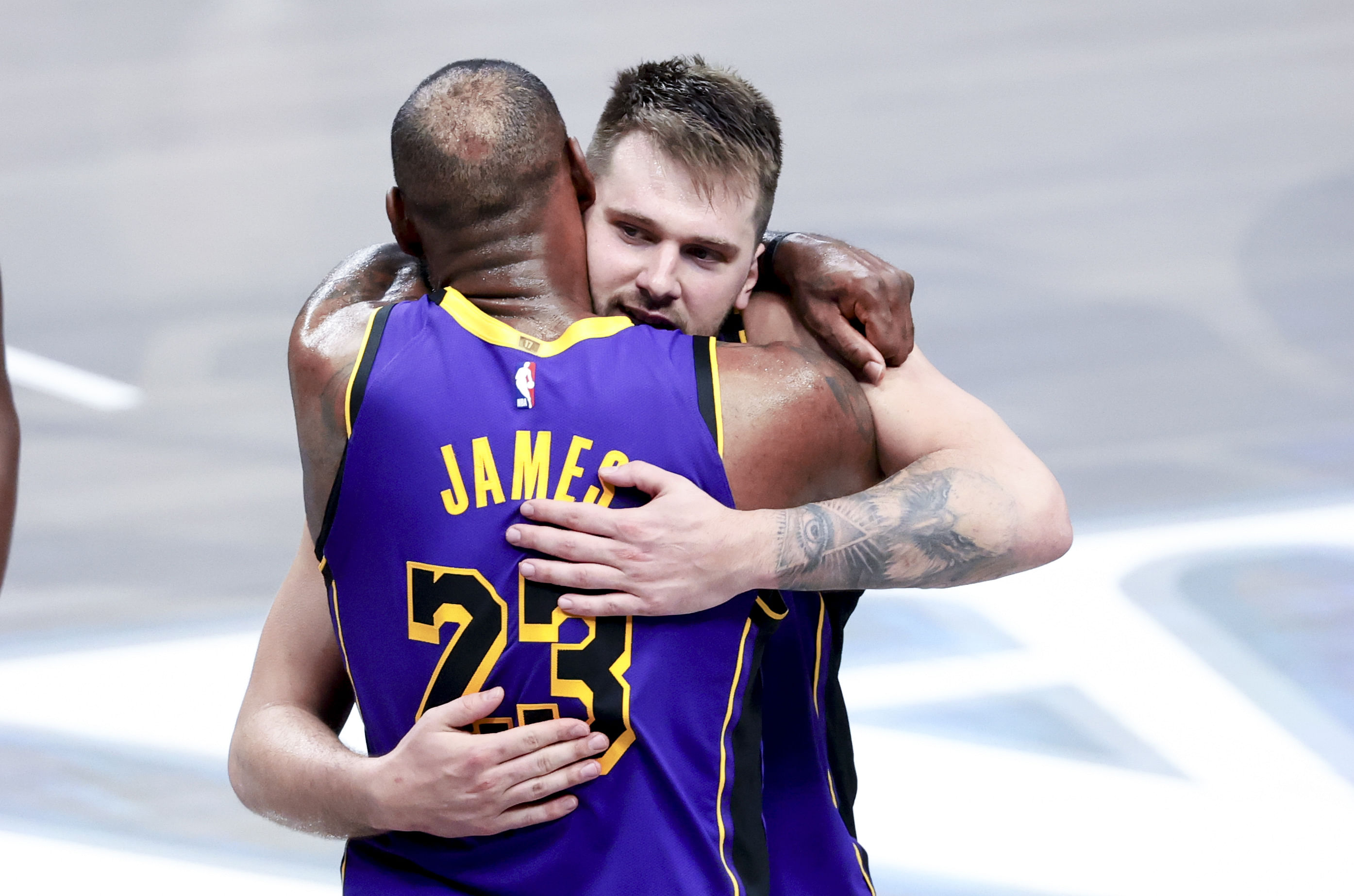 Luka Doncic celebrates with LeBron (facing) - Source: Imagn